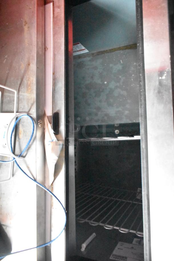 Interior view of a new Metro C5 holding cabinet with wire shelving, part of an 8.5' x 28' Wendy's mobile kitchen trailer.