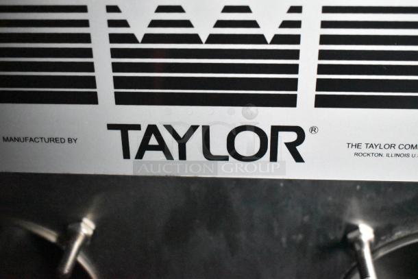 Label on Taylor ice cream equipment, showing brand name and manufacturing location, Rockton, Illinois.