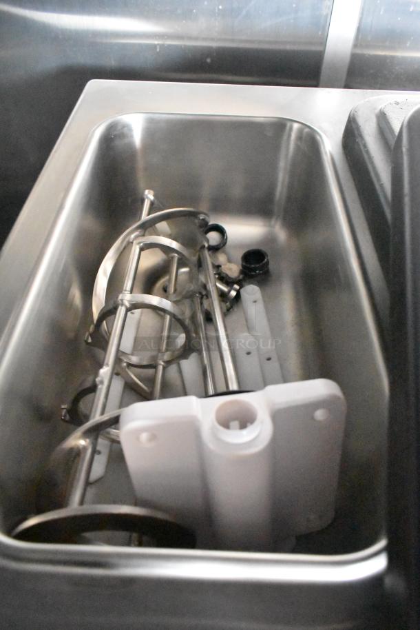Stainless steel sink with mixer components inside, part of a new 8.5' x 28' Wendy's mobile kitchen trailer.