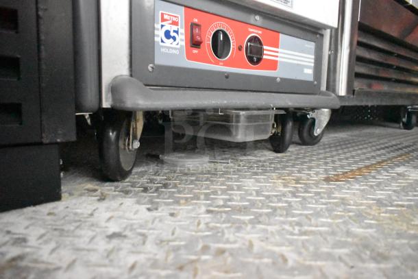Metro C5 holding cabinet on wheels in a fully equipped mobile kitchen trailer. Item appears unused.