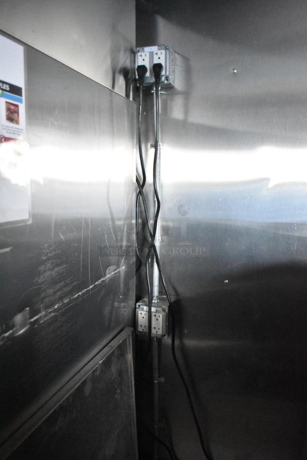 Interior of a Wendy's mobile kitchen trailer showing electrical outlets and wiring, highlighting the new and unused condition.