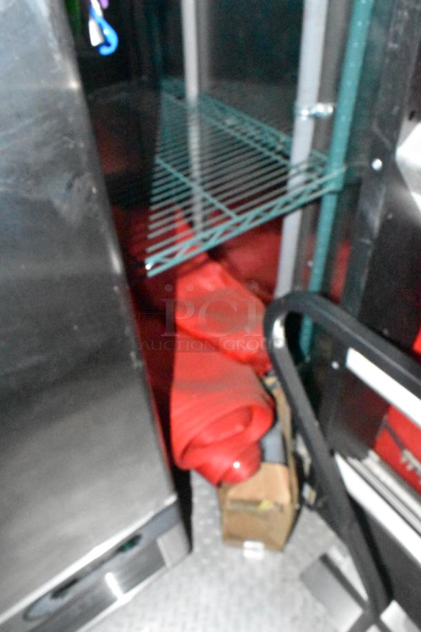 Interior of a new 8.5' x 28' Wendy's mobile kitchen trailer, showing stainless steel equipment and storage racks.
