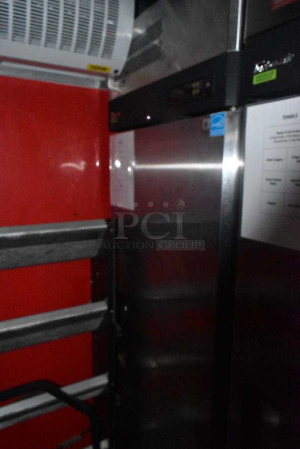 Interior of a brand new 8.5' x 28' Wendy's mobile kitchen trailer, showing refrigeration unit and red wall panels.