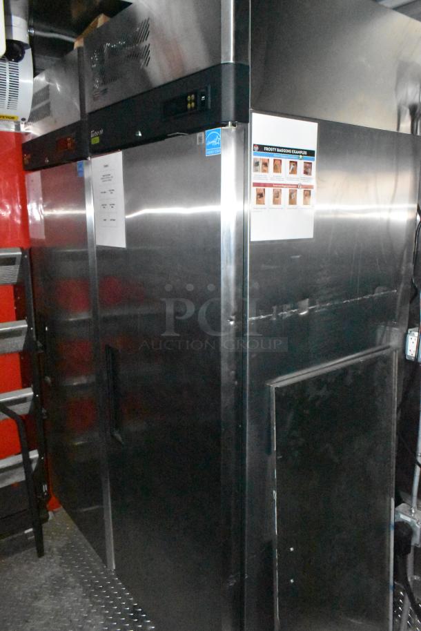Brand new Wendy's mobile kitchen trailer interior with stainless steel equipment, including refrigeration units and labeled instructions.
