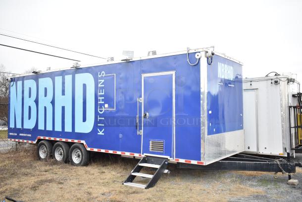 2021 Rock Solid Cargo 28' fast food trailer with kitchen equipment; blue exterior with NBRHD Kitchens branding; includes CaptiveAire hood, Nieco broiler, Frymaster fryer, True freezers, coolers, holding bins, and sinks.
