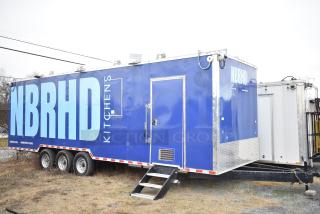 2021 Rock Solid Cargo 28' fast food trailer with kitchen equipment; blue exterior with NBRHD Kitchens branding; includes CaptiveAire hood, Nieco broiler, Frymaster fryer, True freezers, coolers, holding bins, and sinks.