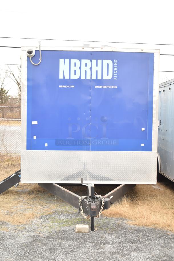 2021 Rock Solid Cargo 28' fast food trailer, blue exterior, branded "NBRHD Kitchens," equipped for mobile kitchen use.