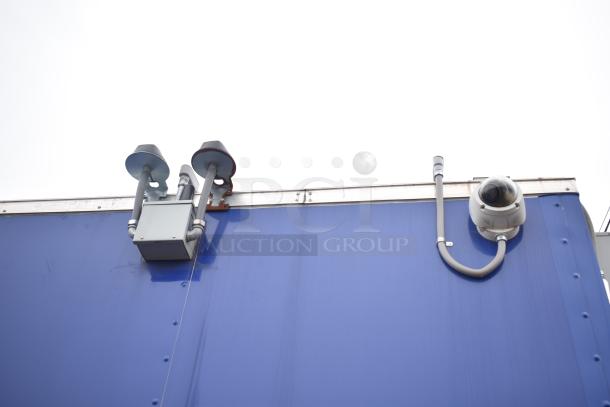 Blue exterior of 2021 Rock Solid Cargo 28' mobile kitchen, featuring external equipment and security camera.