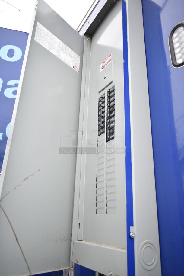 Open electrical panel in the 2021 Rock Solid Cargo 28' fast food trailer, highlighting circuit breakers for kitchen equipment.