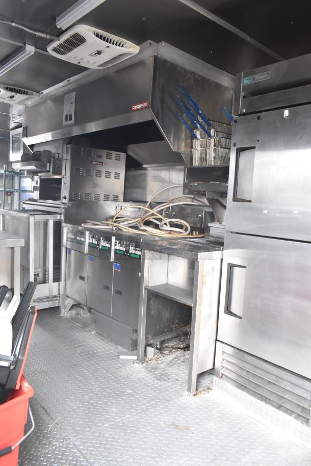 2021 Rock Solid Cargo 28' mobile kitchen trailer with commercial-grade equipment, including CaptiveAire hood, Nieco broiler, and Frymaster fryer.