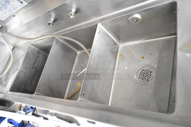 Stainless steel sink setup in 2021 Rock Solid Cargo fast food trailer. Features multiple basins in commercial kitchen.