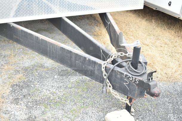 2021 Rock Solid Cargo 28' trailer hitch and chain detail, suitable for a mobile kitchen, with minor wear.