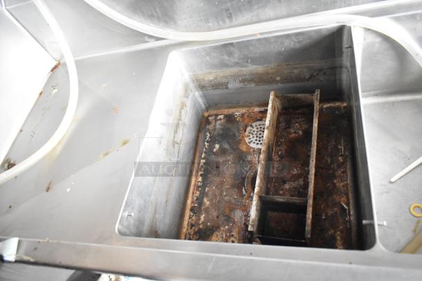 Rusted commercial sink inside 2021 Rock Solid Cargo fast food trailer with visible wear and drain strainer.