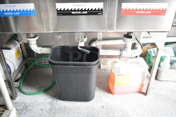 Rock Solid Cargo 28' fast food trailer water line system with labeled rinse, wash, sanitize stations, trash bin, and cleaning supplies.