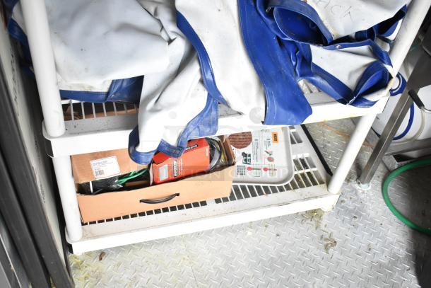 Interior view of a 2021 Rock Solid Cargo fast food trailer shelving with various supplies and equipment.