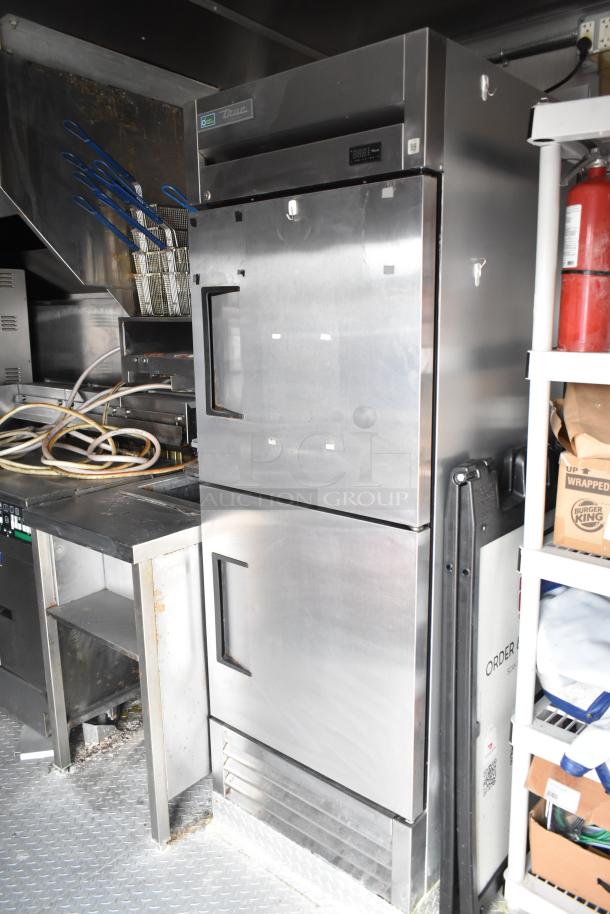 2021 Rock Solid Cargo 28' fast food trailer interior with commercial kitchen appliances including True freezer and fryers.