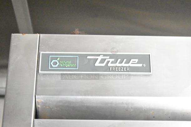True freezer tag on stainless steel surface, indicating use of natural refrigerant. Part of mobile kitchen equipment.
