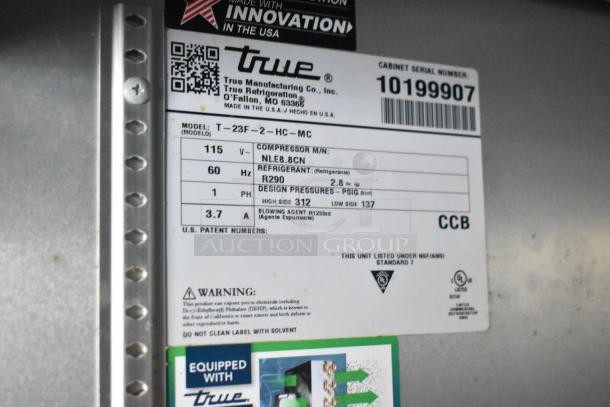 Label on True cooler model T-23F-2-HC-MC, includes electrical and refrigerant specifications. Serial number 10199907.