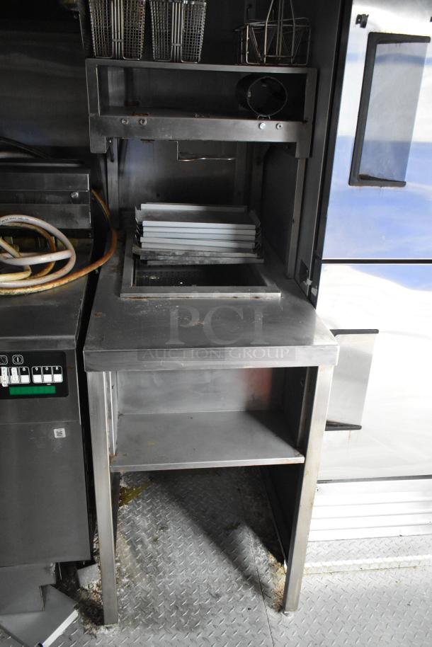 Rock Solid Cargo 28' fast food trailer interior with industrial appliances and stainless steel counters.