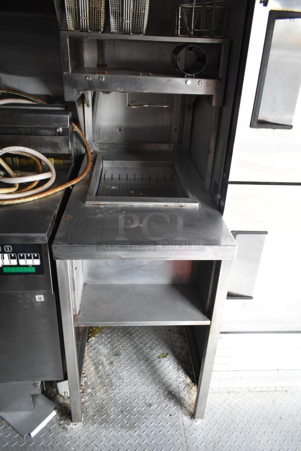 2021 Rock Solid Cargo 28' fast food trailer interior, equipped with commercial gear, including a grease hood and fry baskets.