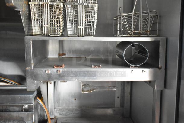 Interior of 2021 Rock Solid Cargo food trailer showing fry basket holders and commercial kitchen equipment.