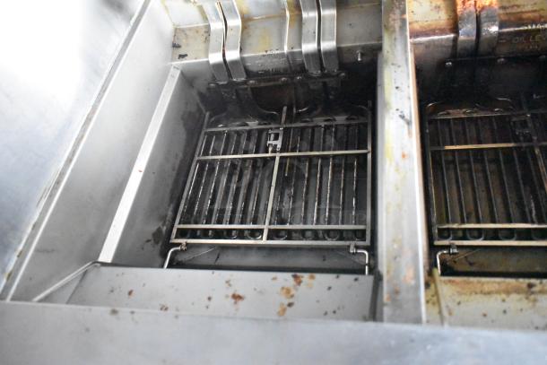 Interior view of commercial-grade Nieco broiler in 2021 Rock Solid Cargo fast food trailer, showing grill and oil level markings.