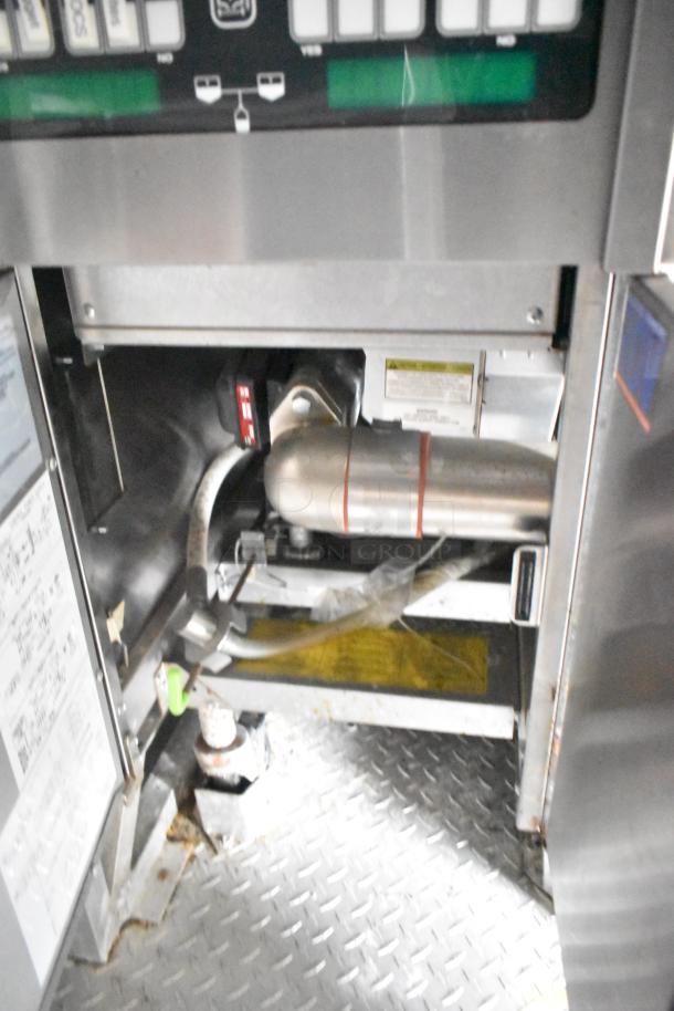 Interior view of a 2021 Rock Solid Cargo 28' fast food trailer showing commercial-grade kitchen equipment on metal flooring.