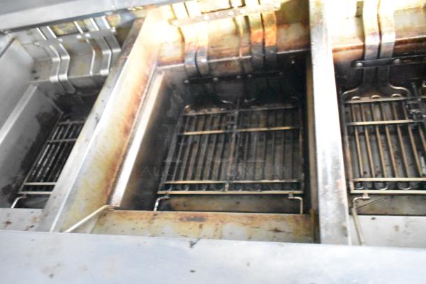 2021 Rock Solid Cargo 28' mobile kitchen with Frymaster 3 bay fryer, visible wear, ideal for fast food setup.