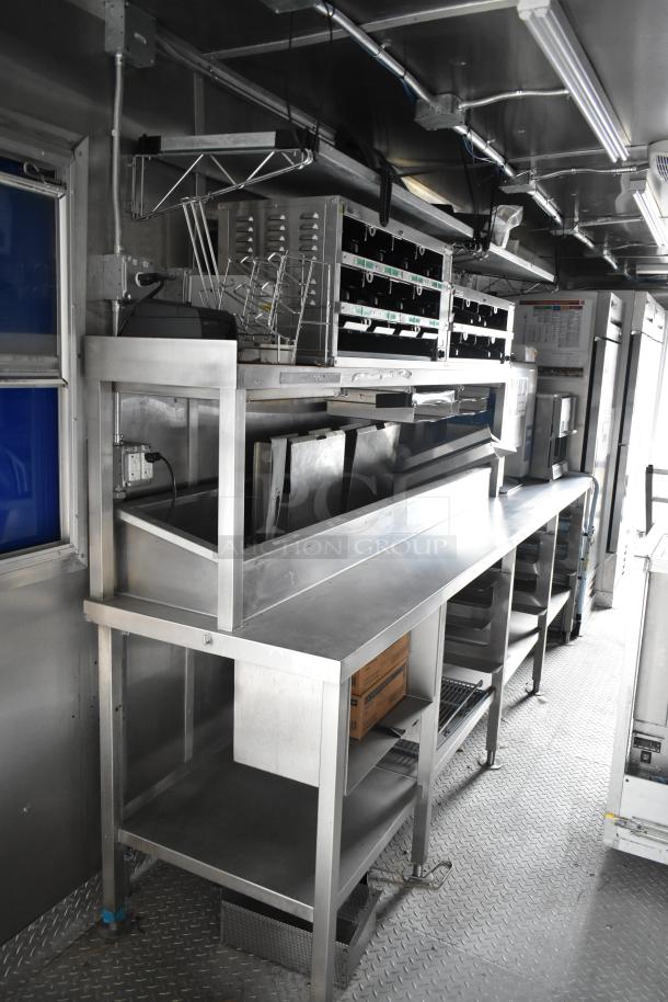 2021 Rock Solid Cargo 28' mobile kitchen, fully equipped with stainless steel counters, CaptiveAire hood, Nieco broiler, and True freezers.