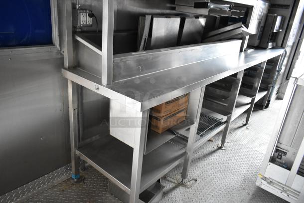 2021 Rock Solid Cargo 28' fast food trailer interior, featuring stainless steel countertops and commercial kitchen equipment.