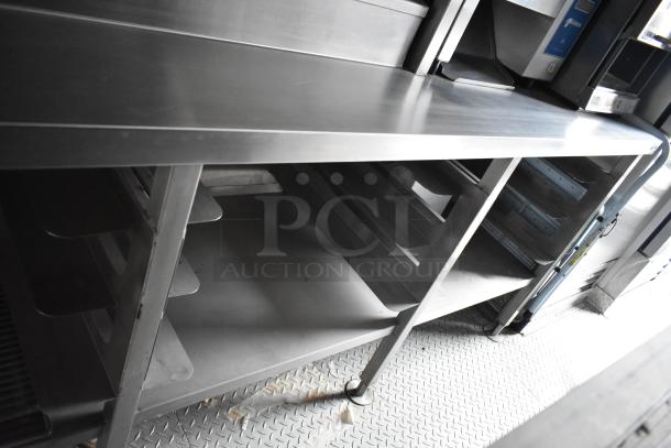 Alt Text: Mobile kitchen's stainless steel counter and shelving, part of a 2021 Rock Solid Cargo 28' fast food trailer.