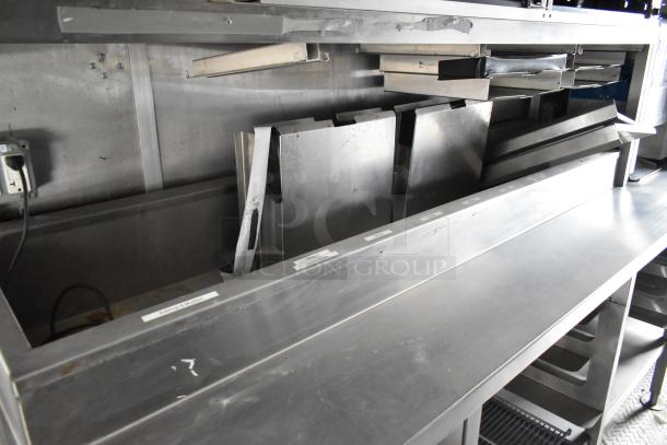 2021 Rock Solid Cargo 28' fast food trailer interior, showcasing stainless steel preparation surfaces and storage fixtures.