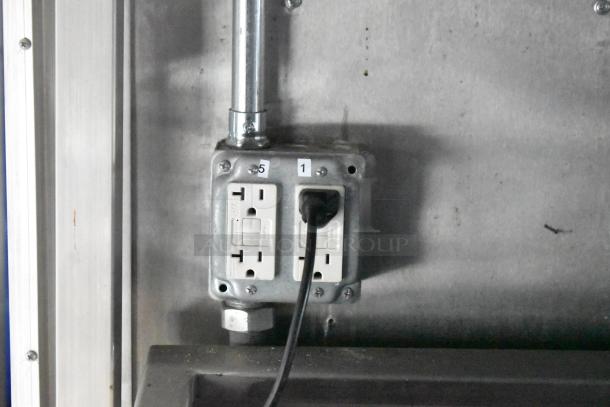 Industrial electrical outlet in a 2021 Rock Solid Cargo mobile kitchen trailer, equipped for fast food service.