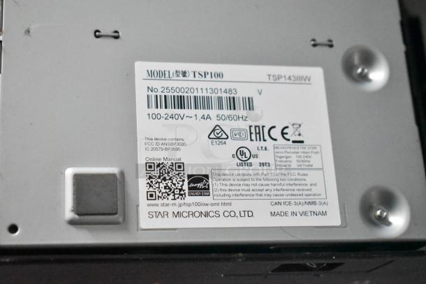 Sticker on device showing model TSP100 by Star Micronics Co., Ltd., including power ratings and compliance information.