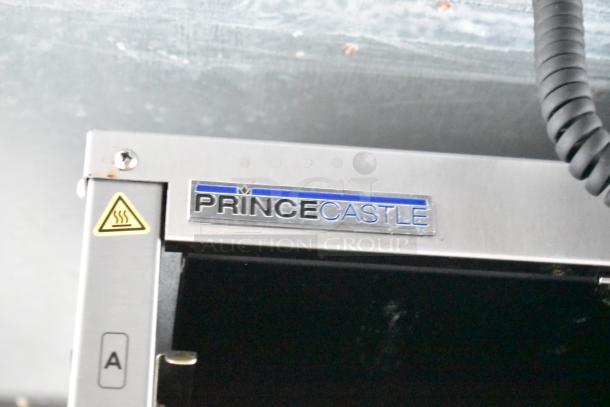 "Prince Castle appliance with brand logo and caution symbol, part of Rock Solid Cargo mobile kitchen setup."