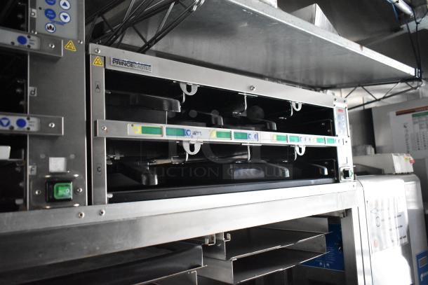 2021 Rock Solid Cargo 28' fast food trailer interior with Prince Castle equipment, grease hood, and stainless steel fixtures.