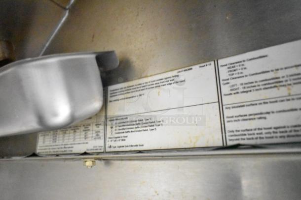 Metal surface and instructional label inside 2021 Rock Solid Cargo fast food trailer, detailing hood installation specifications.