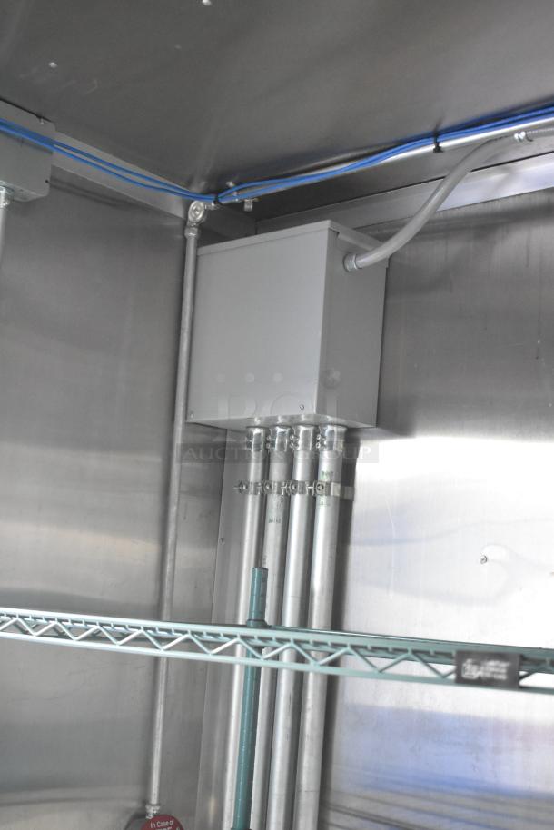 Interior of a 2021 Rock Solid Cargo 28' fast food trailer showing electrical conduit and metal shelving.