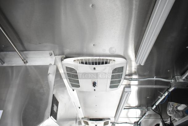 Interior view of 2021 Rock Solid Cargo 28' fast food trailer, showing air vent system on stainless steel ceiling.