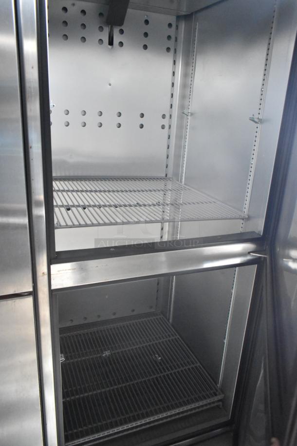 Interior of a Rock Solid Cargo trailer showing stainless steel shelving, part of a mobile kitchen setup with commercial equipment.