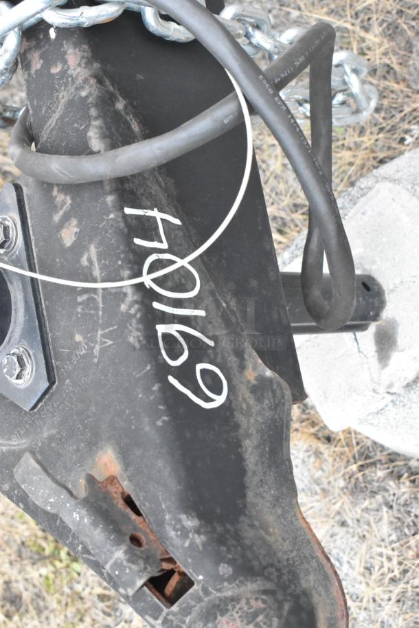 Close-up of a 2020 ATX trailer hitch with visible wear and rust, featuring a marking "40169" in white.