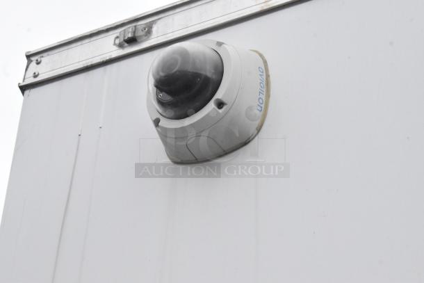 Security camera mounted on the exterior of a 2020 ATX 8.5' x 24' trailer. "Avigilon" label visible.