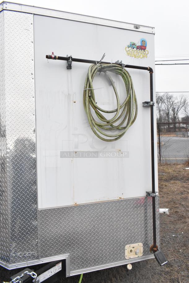 2020 ATX 8.5' x 24' trailer; diamond plate accents, hose storage, "Covered Wagon" logo, single axle. Clear title included.