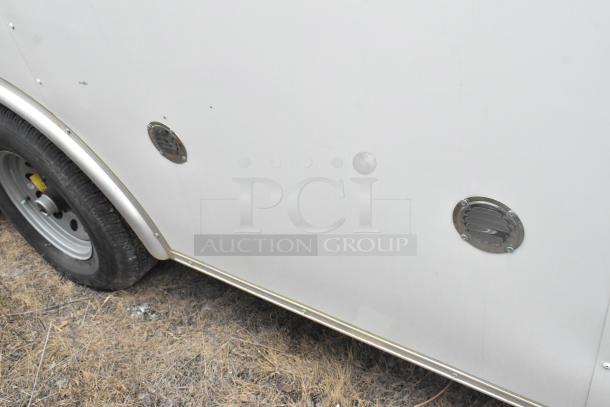 2020 ATX 8.5' x 24' cold food trailer, showing side exterior with wheel and vents. Equipped with CaptiveAire hood and Arctic Air appliances.