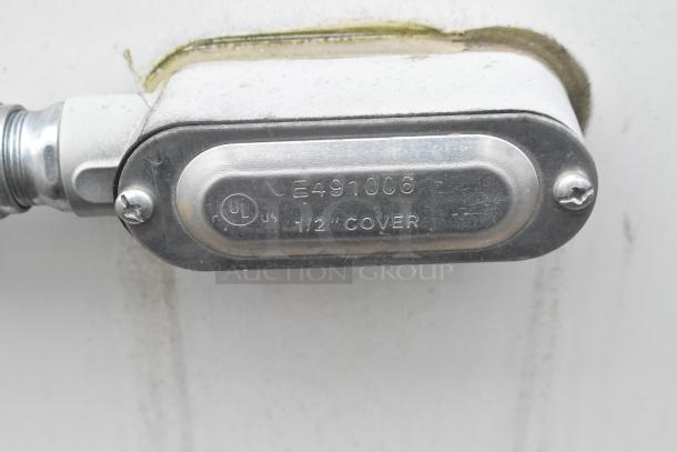 Metal electrical conduit cover with text "E491006 1/2 COVER" and a UL certification mark.