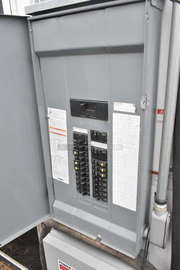 Electrical panel inside the 2020 ATX 8.5' x 24' food trailer, showing breaker switches and safety labels.