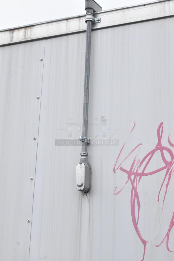 Exterior of a 2020 ATX 8.5' x 24' food trailer, showing metal siding with graffiti, piping, and weathered condition.