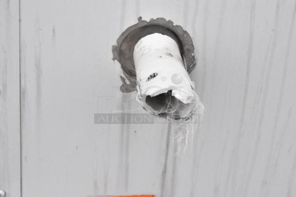 Damaged exterior section of the 2020 ATX 8.5' x 24' fulfillment trailer. Visible wear around a broken pipe protrusion.