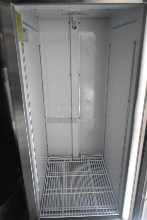 Interior of an Arctic Air cooler featuring wire shelving, clean white walls, and visible shelving brackets, optimized for food storage.