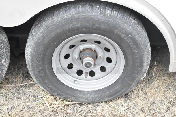 2020 ATX single axle tire on 8.5' x 24' trailer. Visible tread wear, Castle Rock radial ST tire, steel rim.